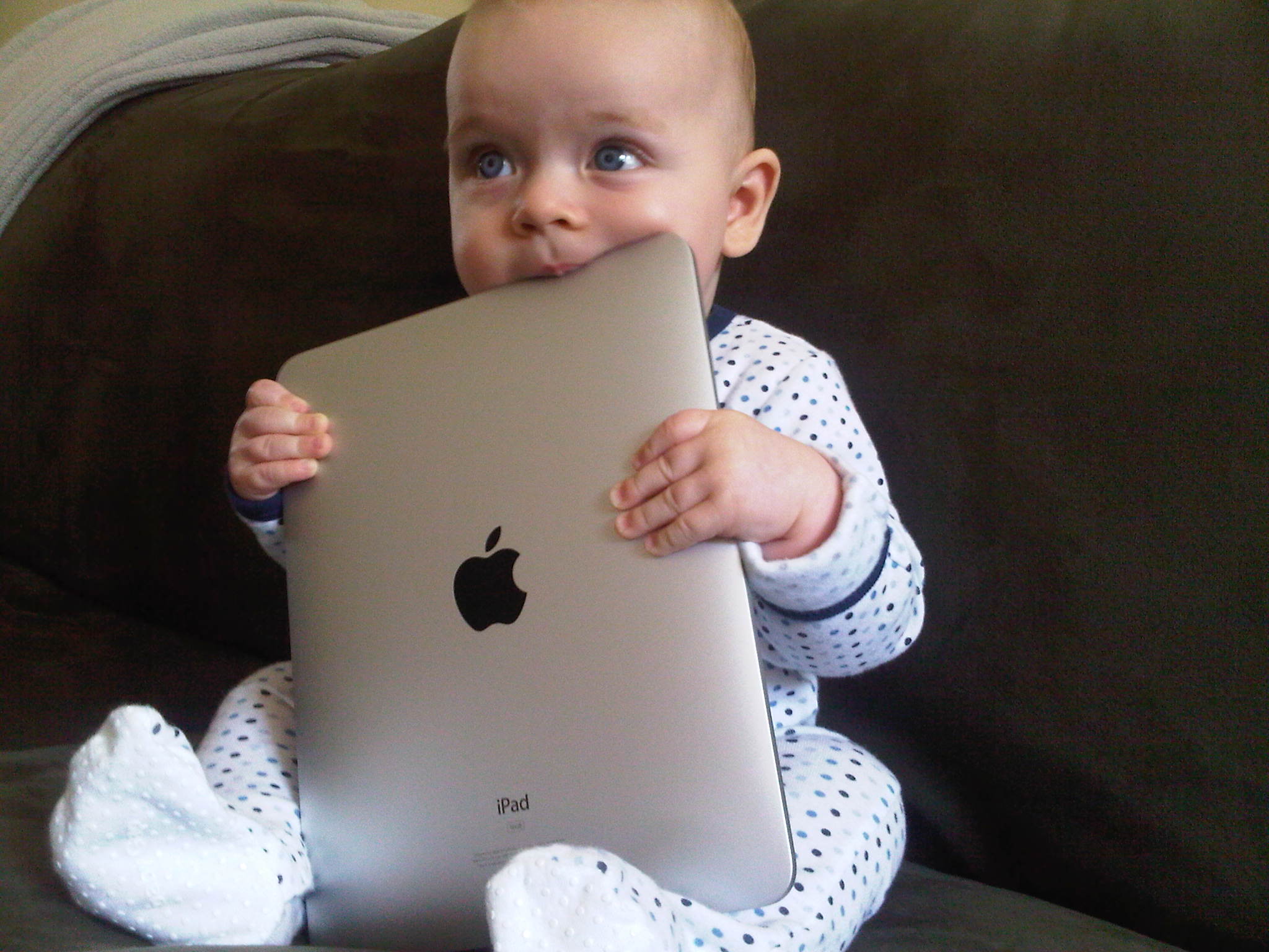 Baby holding Apple iPad